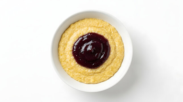 Authentic Torkarebl cornmeal porridge topped with rich plum jam. Traditional Liechtenstein breakfast dish isolated on a solid white background