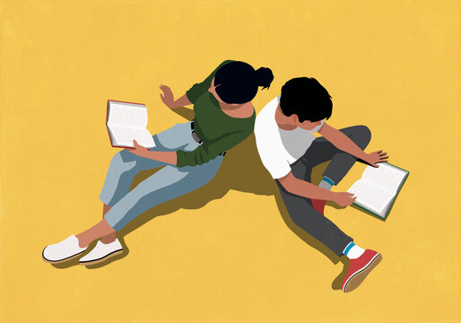 High angle view of woman and boy reading books back to back against yellow background