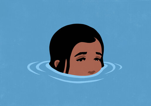 Close up of sad girl's face partially submerged in blue water