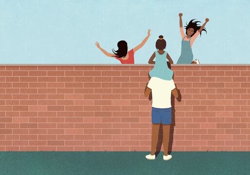 Girl on father's shoulders looking over all at girls playing and jumping