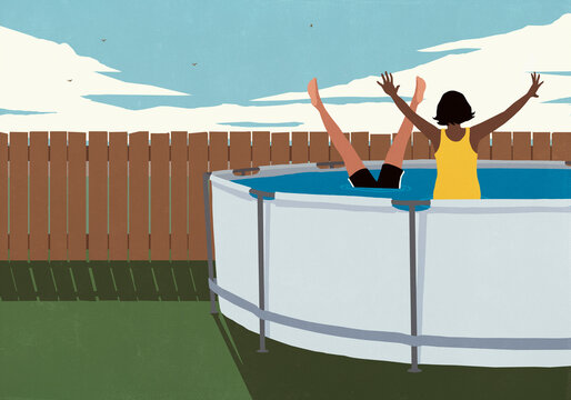 Carefree couple playing in above-ground swimming pool in summer backyard