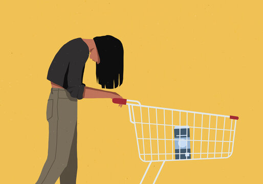 Woman with head down pushing shopping cart against yellow background