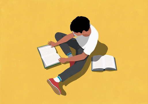 Boy reading books on yellow background