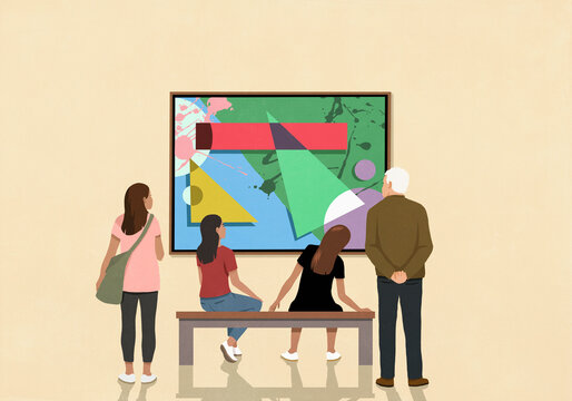 Visitors looking at abstract art hanging on museum wall