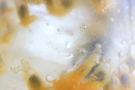 passion fruit lemonade background, cold lemonade in a glass, delicate texture cold tropical drink background