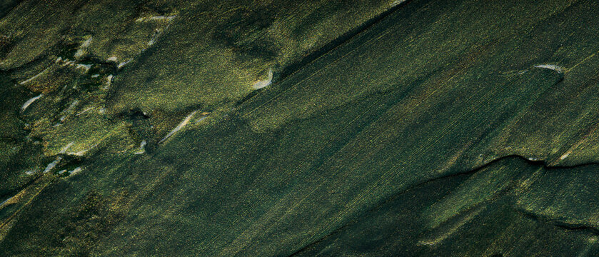 Dark green and gold abstract textured background with flowing diagonal patterns and shimmer