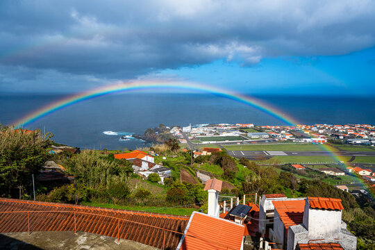 Landscape of the airport runway with a rainbow. Flores Island, Azores, Portugal.