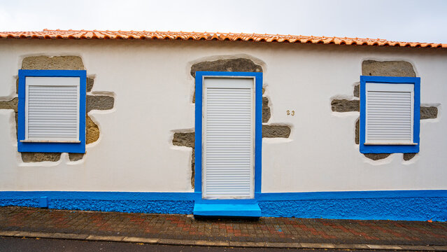 White house facade with blue outlines, typical of Santa Cruz das Flores, Flores Island in the Azores, Portugal.