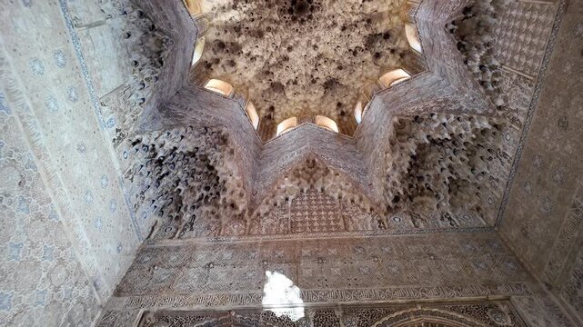 Intricate Moorish decorations cover the walls and ceilings of the Alhambra Palace, Granada, Andalusia, Spain.
