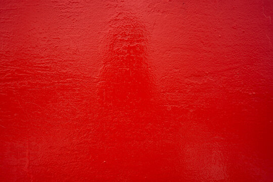 Rough metallic surface painted red.