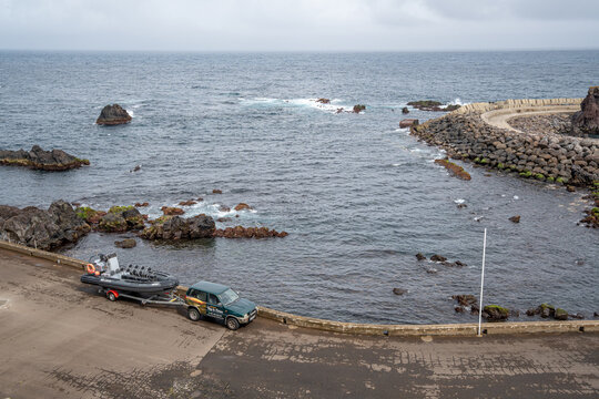 Jeep towing a semi-rigid boat that makes the inter-island crossing from Corvo to Flores Island, Azores, Portugal.