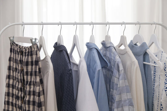 Blue and White Summer Wardrobe on Clothing Rack, Summer Vacation Fashion Collection, Clean Minimal Clothing Display, Fresh Coastal Summer Style, Light and Airy Seasonal Outfit Arrangement