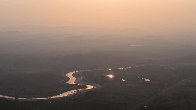 Golden sunset bathes winding river