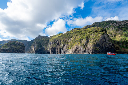 Typical rock formations with waterfalls in the ocean near Flores Island, Azores, Portugal.