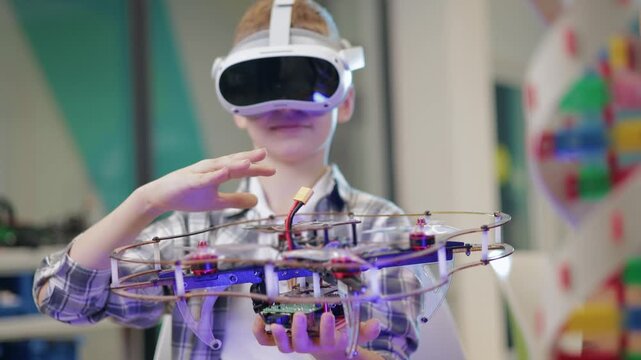 Kid boy wearing vr headset manipulating robot drone in classroom makerspace with subtle handheld pan and tilt movement.