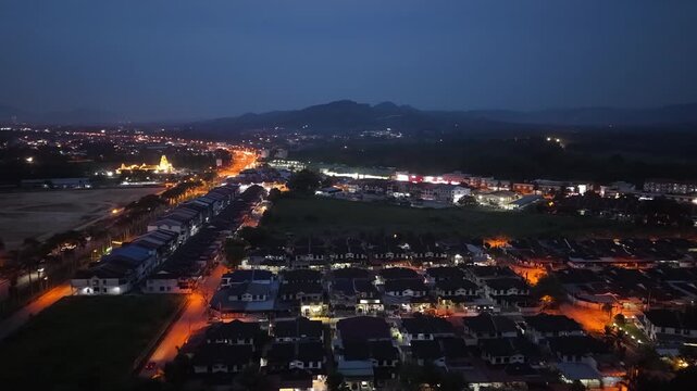 Drone footage showing nighttime car traffic and residential area in Jawi, Penang.