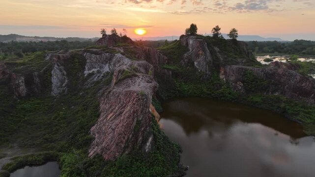 Sunrise aerial view of Frog Hill Kubang Semang quarry lake and surrounding cliffs.