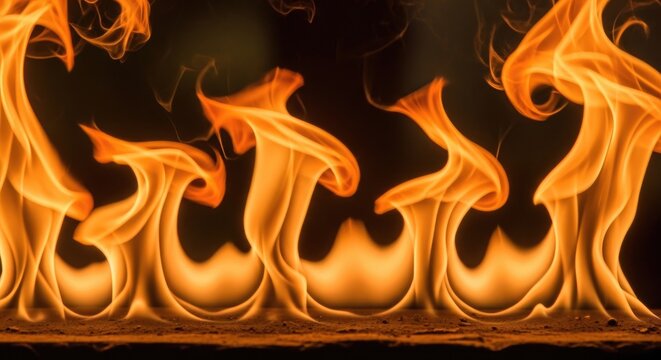 Close-up of vibrant orange flames dancing against a dark background, symbolizing energy and heat.