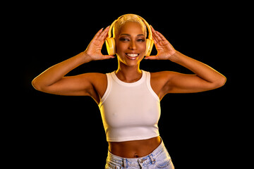 Smiling and dancing woman in headphones.