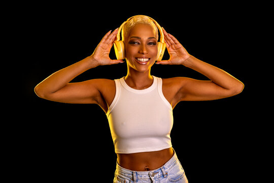Smiling and dancing woman in headphones.