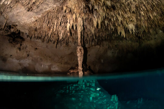 Air pocket chamber inside cenote cave system showing underwater passage and limestone ceiling