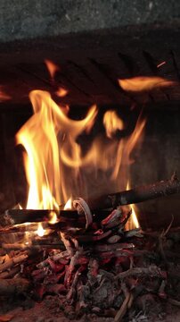 Orange flames and glowing embers creating warmth and heat in a fireplace