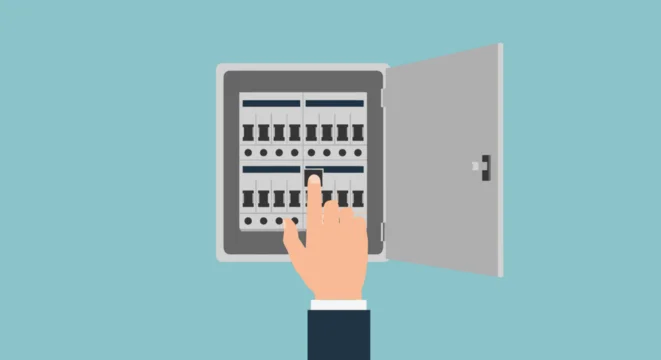 Hand adjusting electrical circuit breaker panel switches carefully.