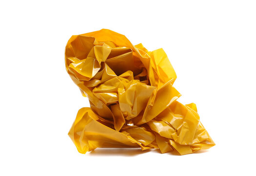 Crumpled up yellow duct and paper repair tape, ball lump isolated on white background