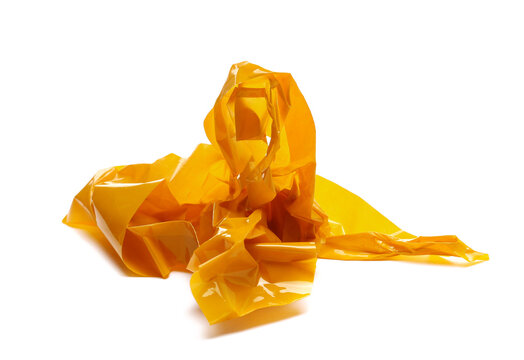 Crumpled up yellow duct and paper repair tape, ball lump isolated on white background