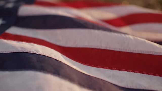 Waving American Fabric Texture Closeup - A soft, flowing texture of American fabric with red and white stripes is shown in a close-up, soft-focus view.