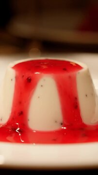 Vanilla Panna Cotta With Raspberry Coulis Dripping Down The Side And Vanilla Bean Specks