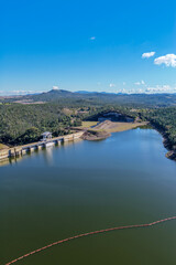 Fototapeta premium Aerial vertical view showcasing the Lake Keepit dam wall, engineering infrastructure and surrounding rural landscape, highlighting the scale of the reservoir and its water storage in NSW, Australia.