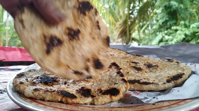 Hot Fresh Roti Flatbread Broken by Hand, Traditional Homemade Bread on Plate, 4K Close-Up Food Video