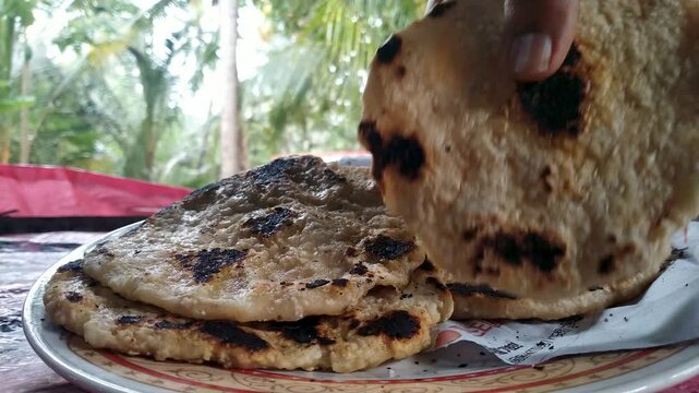Hot Fresh Roti Flatbread Broken by Hand, Traditional Homemade Bread on Plate, 4K Close-Up Food Video