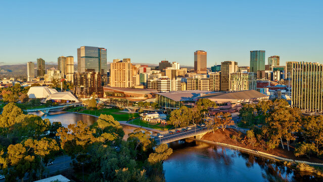 Adelaide City, South Australia &ndash; 4K aerial drone footage of CBD skyline, Towers, River Torrens, Convention Centre, Elder Park, city bridges and golden sunset cityscape.