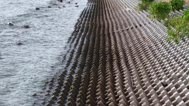 Aerial view of interlocking wave barrier at Ban Pecah coast