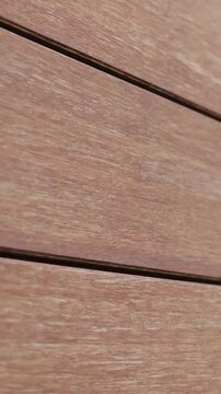 Vertical video. Close-up of red brick facade with clean joints and black corner details.