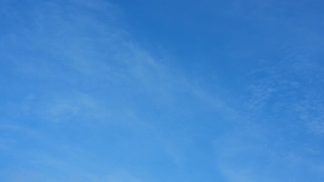 A blue sky timelapse video featuring soft cirrostratus and faint altocumulus cloud textures, suggesting clean atmosphere, sky therapy, mental clarity, peaceful airflow, and dreamlike digital calm. 4k

