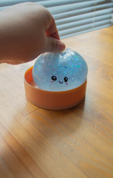 Cute matte Blue plush squishy toy in the shape of a dumpling, stress-relieving, removable from a yellow plastic steamer basket.