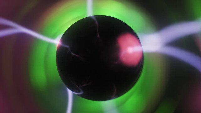 Close-up of a plasma globe with pink and white bolts emanating from a central black electrode. Green ionized gas streams and electric arcs move inside the glass sphere.