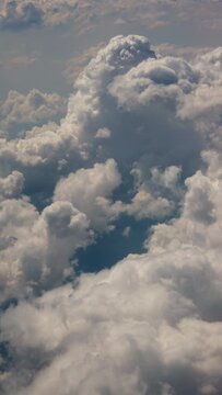 Dramatic white cloudscape above the sky in vertical aerial view.