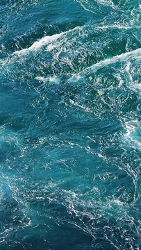Blue waves of water of the river and the sea meet each other during high tide and low tide.