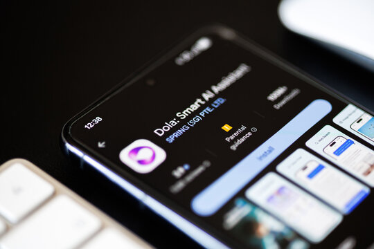Mobile phone displaying Dola Smart AI Assistant on Google Play store in lifestyle situation