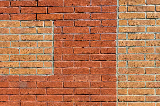 red brick wall with contrasting brick patches