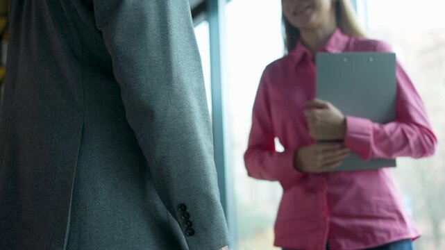 Handshake, greeting and meeting for people in office, welcome or business partners in bank for loan. Finance, startup and women with man for negotiation, lender and assessment of application or funds