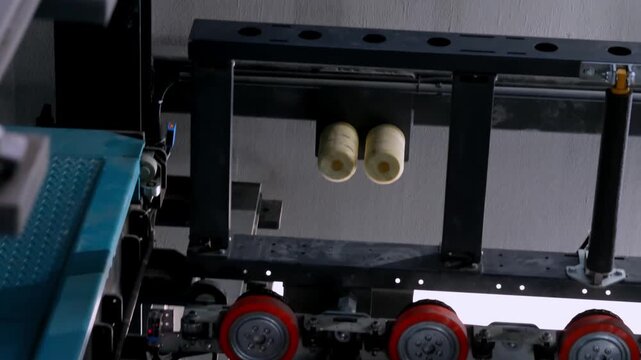 Close-up of a smart parking system mechanism with metal components, rollers, chain drive and safety mesh, showing automated garage technology used for modern vehicle parking operations.