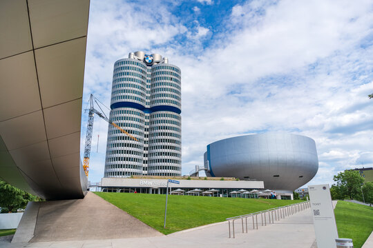 Munich, Germany - June 1, 2026: The iconic BMW Headquarters building featuring its distinctive four-cylinder architectural design beneath a partly cloudy blue sky