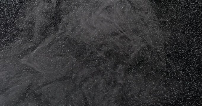 Dark leather texture with a smooth haze. A high-resolution dark leather texture background captured in smooth motion.