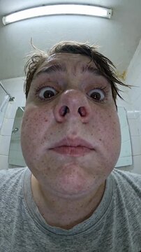 close-up of shocked teen looking into phone