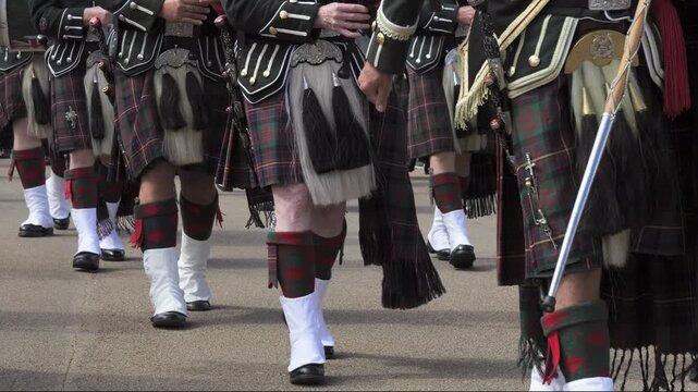 Scottish highland marching band parade in traditional kilts